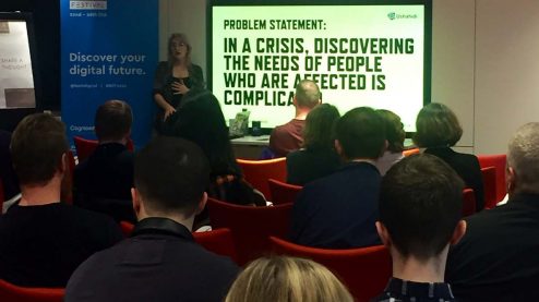 Eriol in front of a slide that says 'Problem Statement: In a crisis, discovering the needs of affected people is complicated'