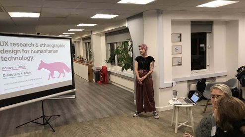 Eriol standing in front of the title slide of their presentation