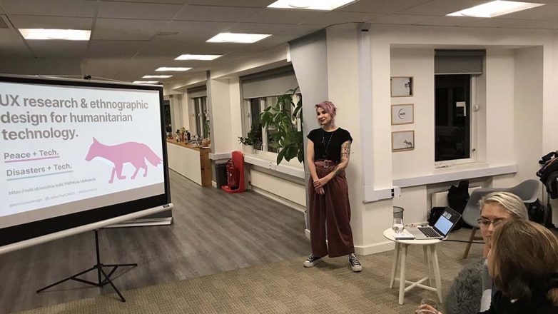 Eriol standing in front of the title slide of their presentation