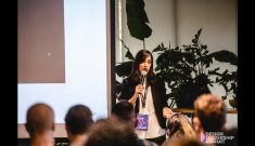 Dana Bright speaking on stage at Design Leadership conference