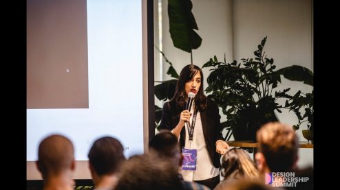 Dana Bright speaking on stage at Design Leadership conference