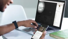 A participant of a digital accessibiility empathy lab, with a persona on his smartphone and a simulation tool on his computer